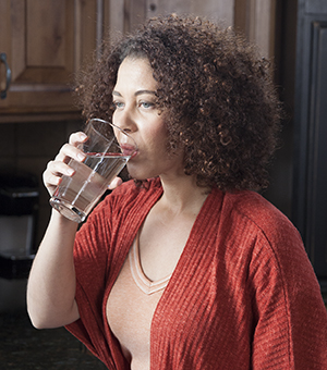 Woman drinking glass of water.