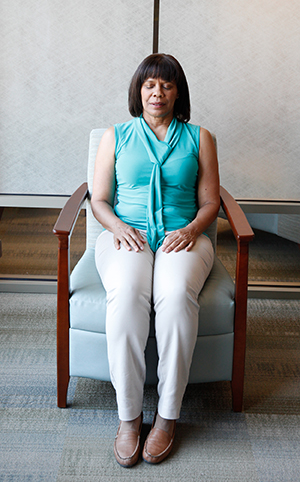 Woman relaxing in chair with eyes closed.