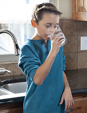 Boy drinking water.