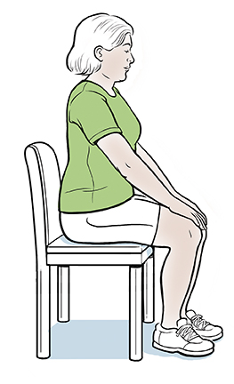 Woman sitting in chair with hands on knees.