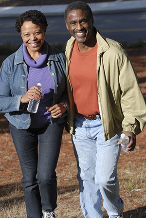 Man and woman walking briskly in comfortable clothes.